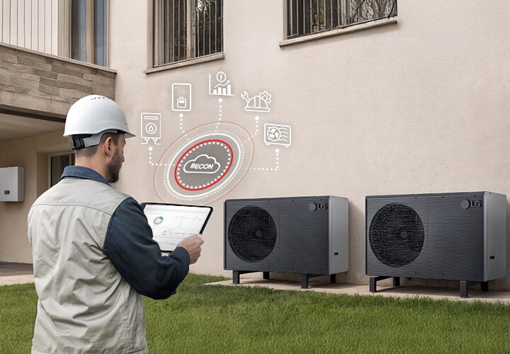 Instalator trzyma tablet, sterując systemem pomp ciepła za pomocą platformy LG BECON Cloud.