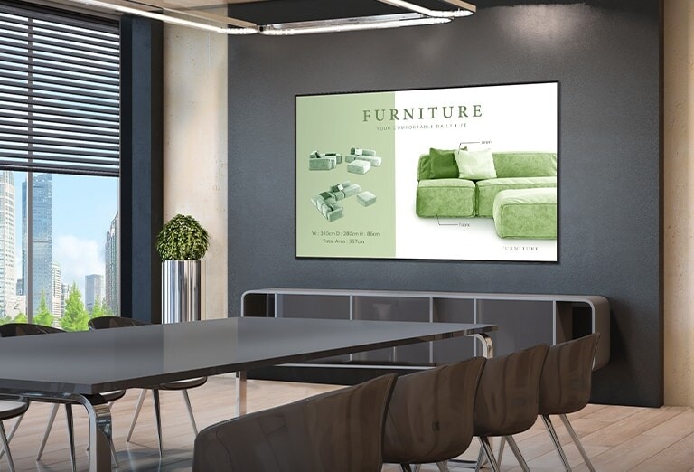 شاشة توضّح المحتويات التي تتم مناقشتها في الاجتماع مثبّتة على حائط غرفة الاجتماعات.