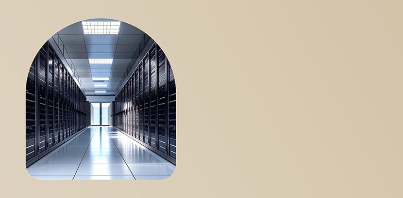 ممر عصري في مركز بيانات تحيط به صفوف من خزائن الخوادم تحت إضاءة ساطعة.