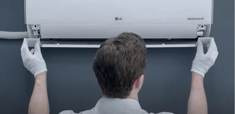 A technician repairing an airconditioner.