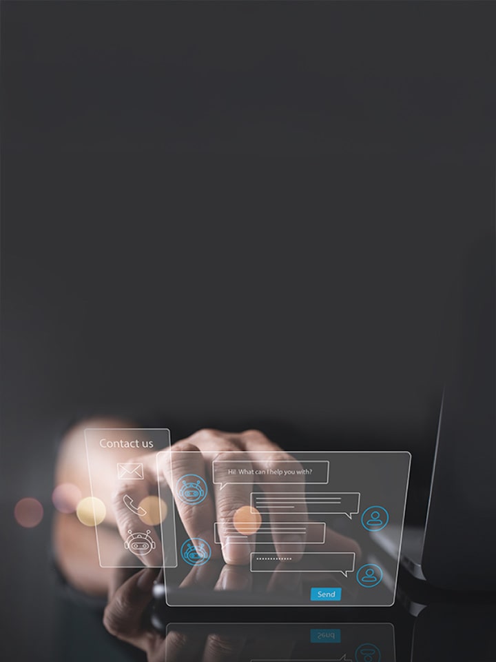 Two virtual hologram windows which are chatting and contact us float next to the laptop and hands are placed behind them.