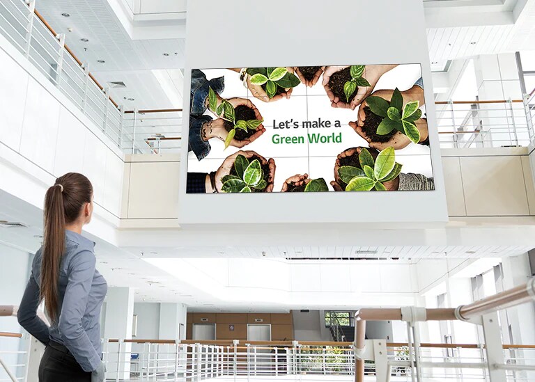 A woman is looking up at the screen installed upstairs.