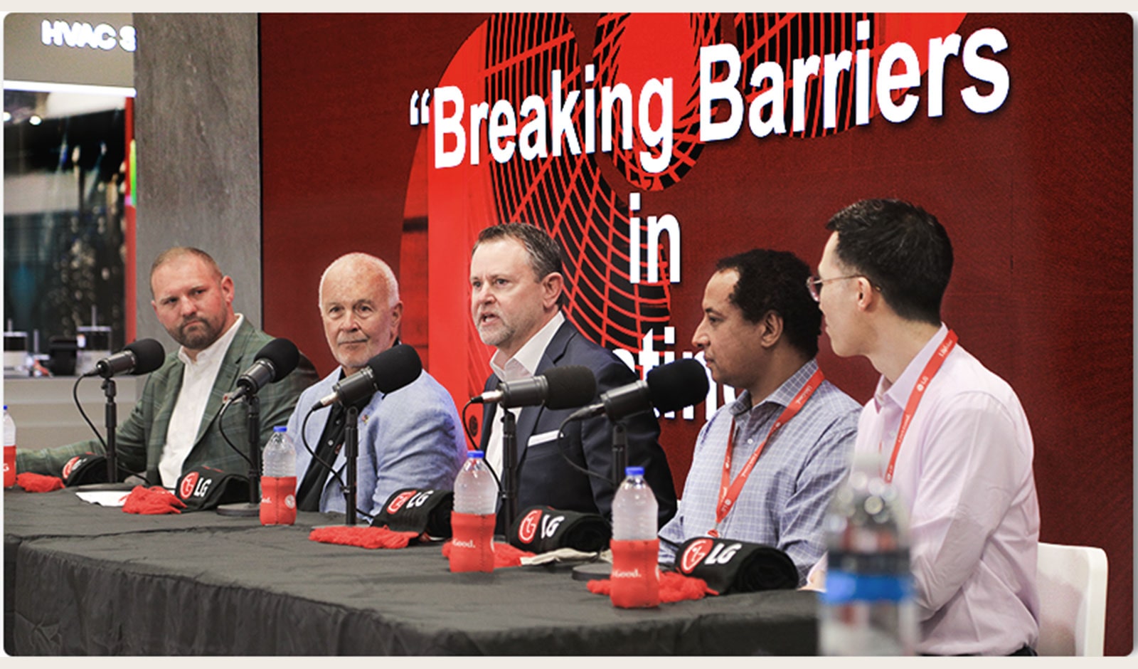Breaking Barriers panel at a conference discussing business and technology, featuring industry professionals.
