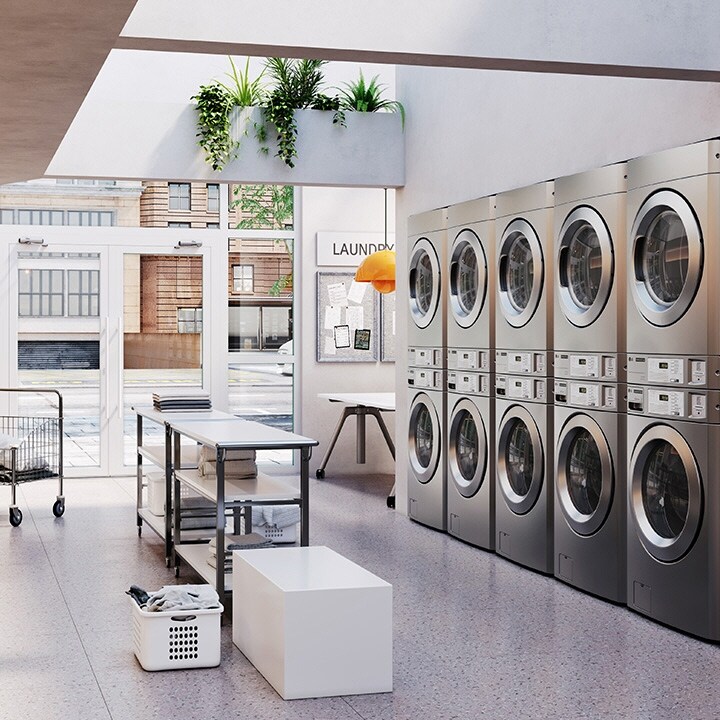 Laundromat with LG commercial washers and dryers arranged in rows with sink