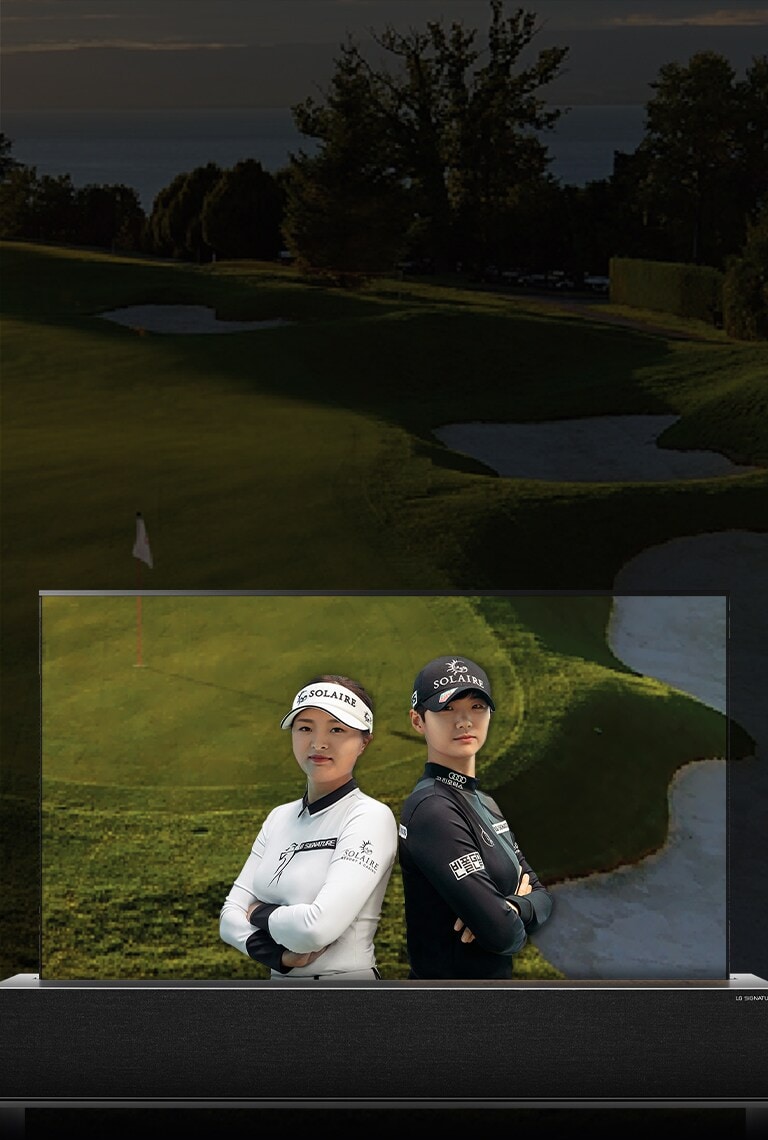 An image of golfers Jin Young Ko and Sung Hyun Park stood back to back displayed on the screen of an LG SIGNATURE OLED R rollable TV.