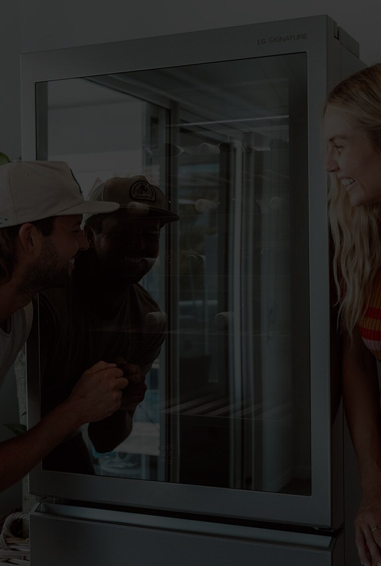 Influencers and previous winners of The Block Australia, Josh Barker and Elyse Knowles in front of the LG SIGNATURE Wine Cellar.