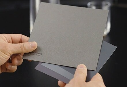 close shot of darren palmer's hands holding a metalic gray color palette chips