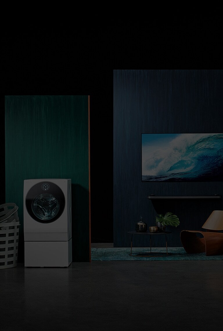 starting from the left, lg signature washing machine, oled tv w, refigerator is displayed with some green and blue wall in some place like a dark studio
