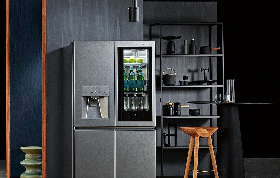 lg signature refrigerator is displayed in the gray tone kitchen with its instaview light turned on