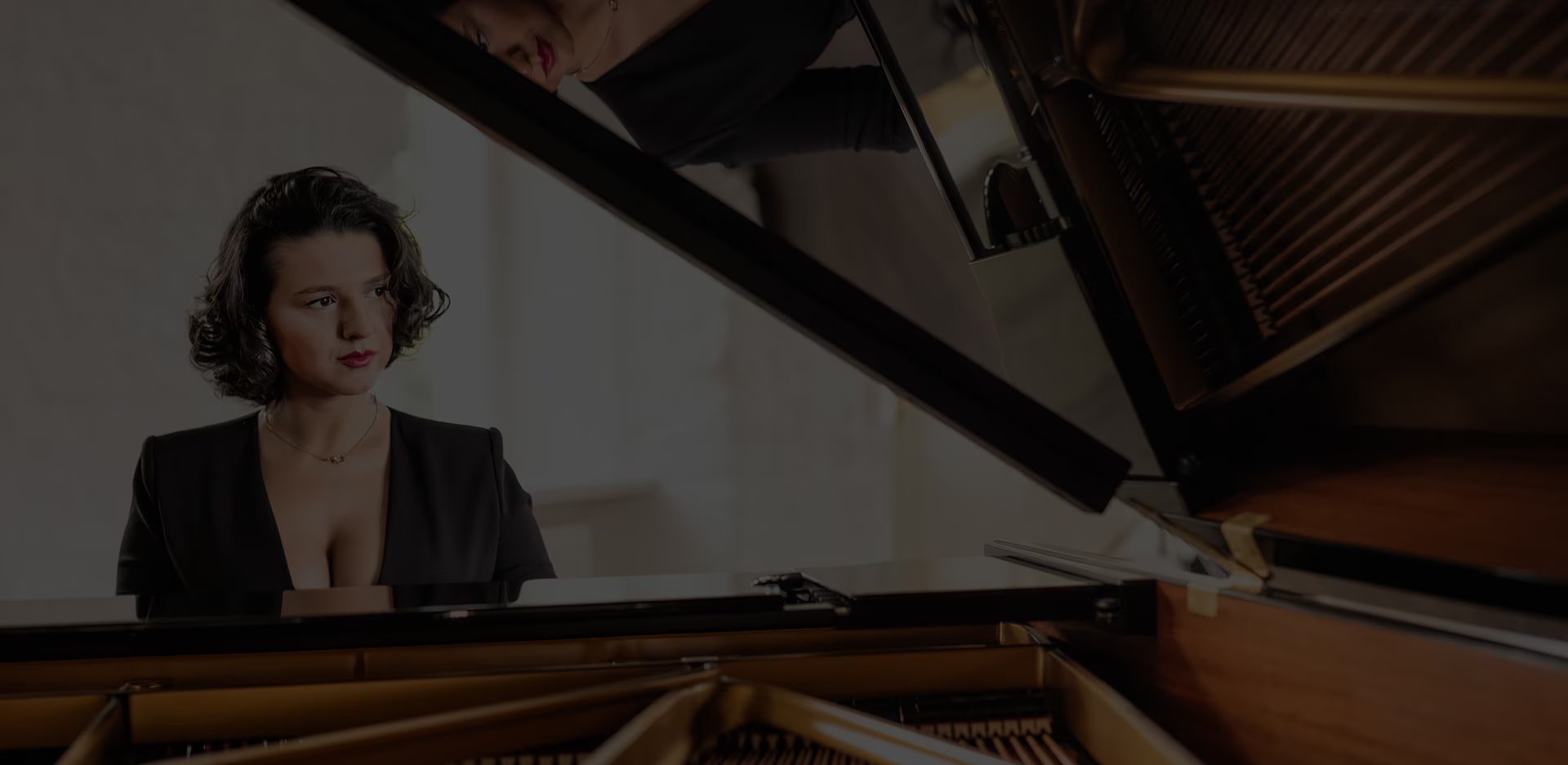 Khatia Buniatishvili is sitting at a piano.