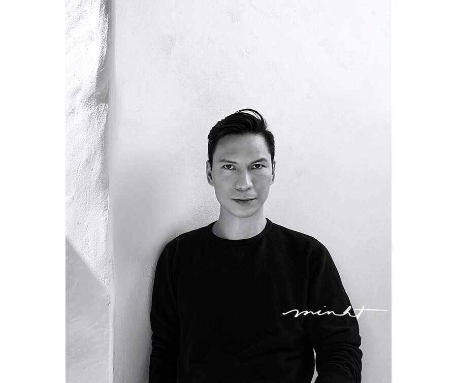a black and white profile image of creator minh tran with his autograph printed on the right side