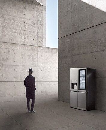 creator and photographer of minh tran is standing in front of lg signature refrigerator and staring it in the overally unique architectural site