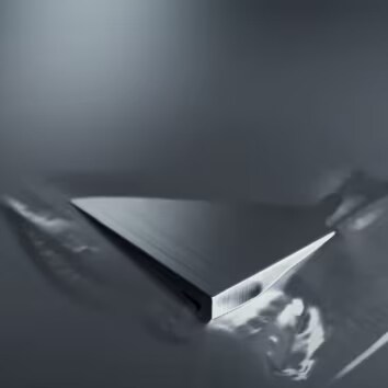 A close up shot of aluminium with the text 'Stainless Steel.'