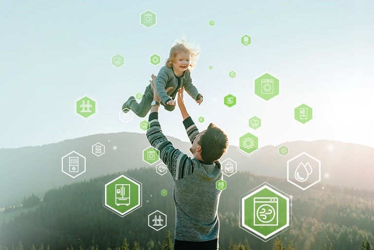 In front of the background where you can see mountains and the sky, the father is holding a smiling child, and the energy icons are floating around them.