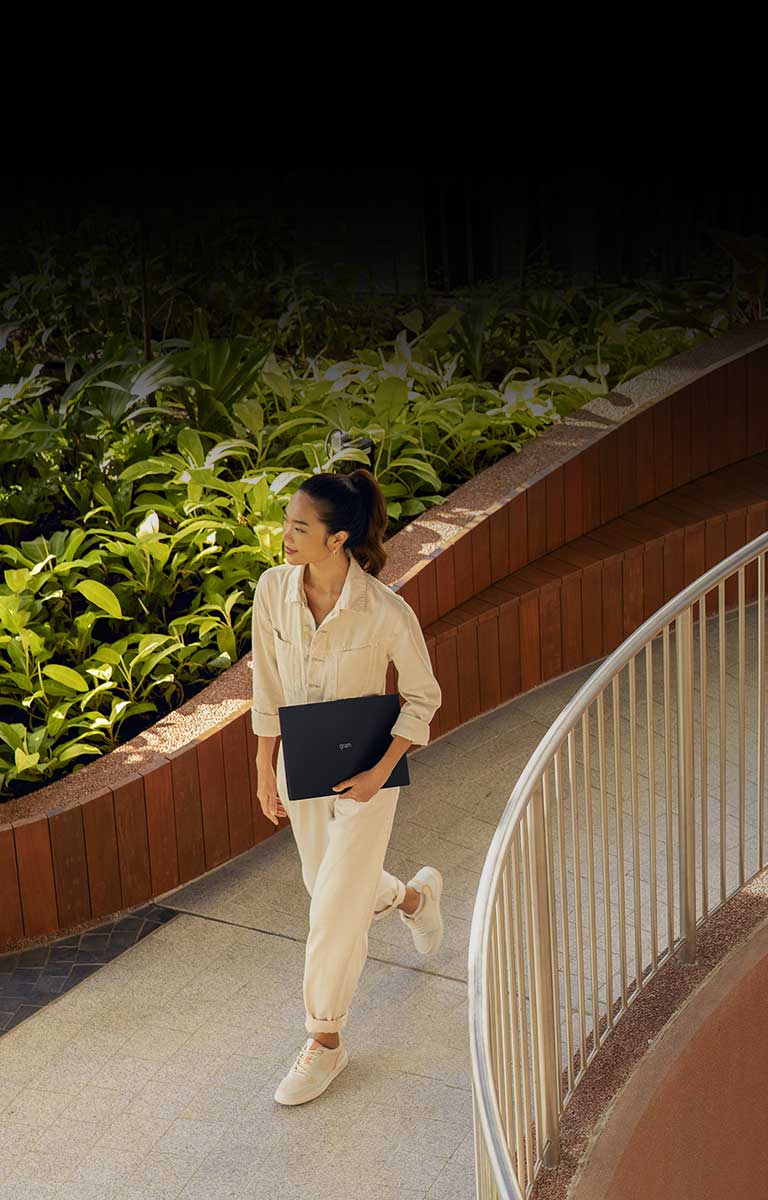 A woman is on the move while holding LG gram.