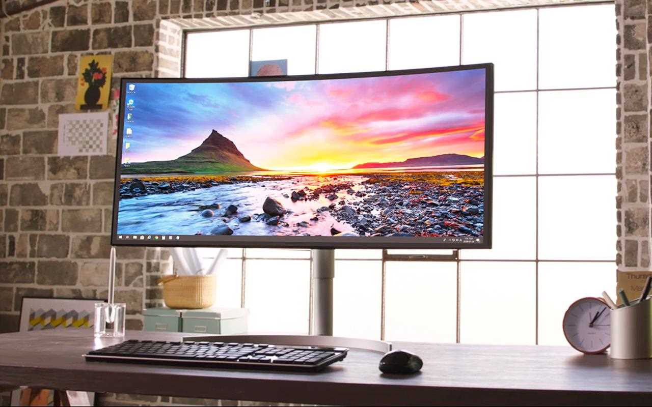 An LG curved monitor sits on a minimal ergonomic desk.
