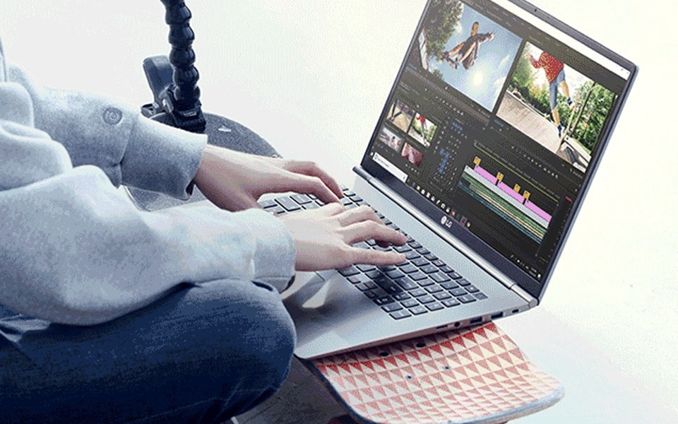 A person editing a video on an LG Gram laptop.
