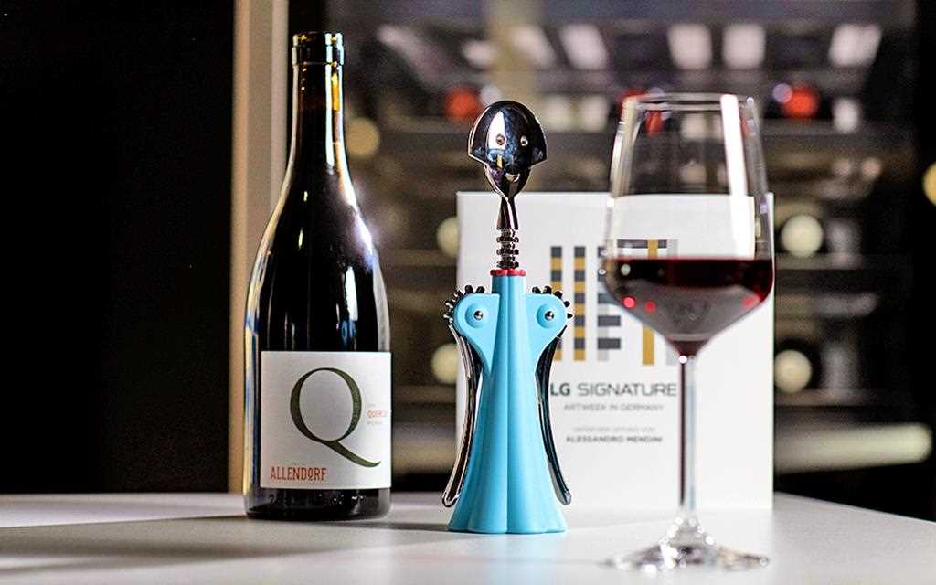 A bottle of Allendorf wine sits next to a limited edition bottle opener during LG SIGNATURE ARTWEEK