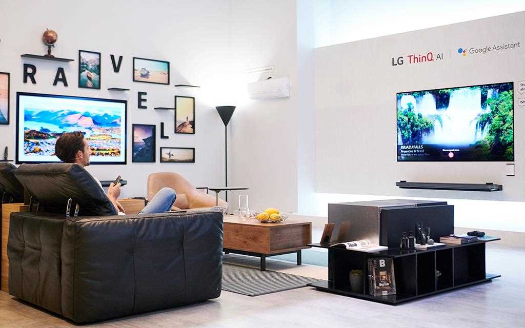 IFA 2018: A demonstrator watches LG OLED TV on his Natuzzi sofa in the travel zone