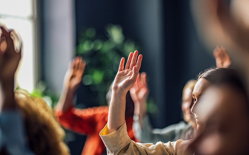 Children raising their hands to ask what is a smart TV