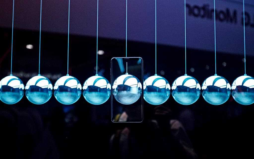 LG V30 smartphone which looks transparent a silver ball.