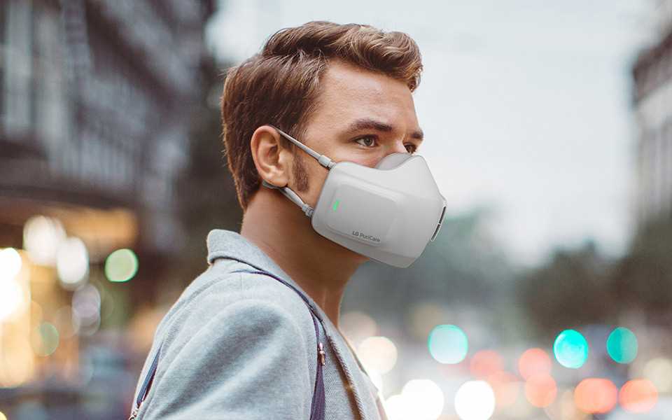 A man wearing the LG PuriCare™ Wearable Air Purifier in public.