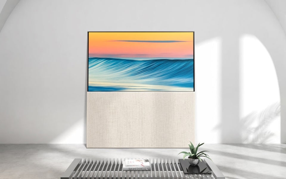 A wall-mounted LG OLED evo Gallery Edition TV.