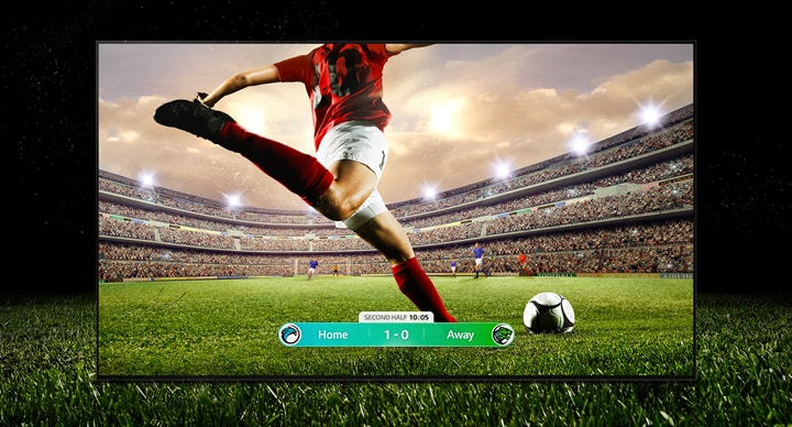 Изображение на экране, показывающее футбольный матч с игроком в красной полосе, который собирается перебросить мяч через стадион.  Счет игры отображается в нижней части экрана.  Зеленая трава с поля простирается за пределы экрана до черного фона.