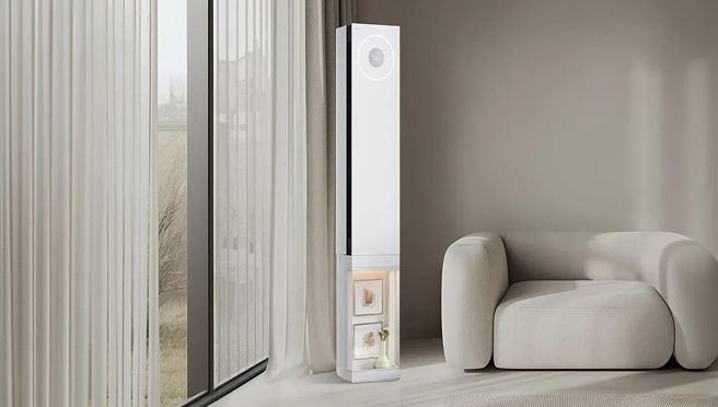 Sleek white LG tower air conditioner with a circular display in a modern, clean living room.