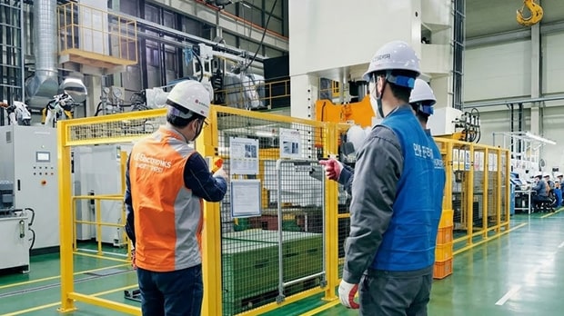 Image of workers in hard hats inspecting facilities