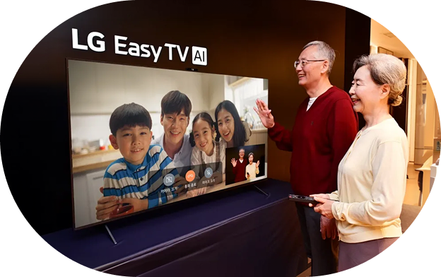 A scene of an elderly couple in a living room holding a remote control and having a video call with their family on the TV screen, with multiple family members visible on the screen