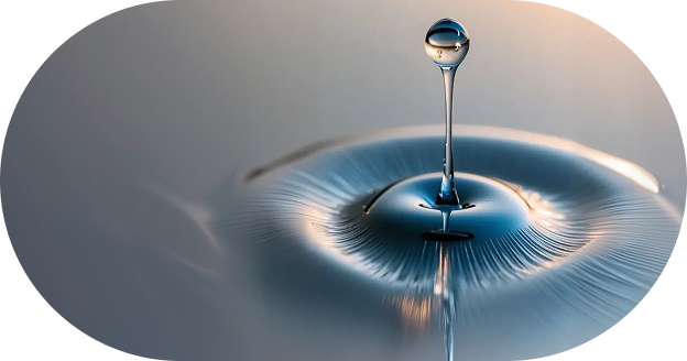 A close-up of a water droplet falling into clear water, creating ripples