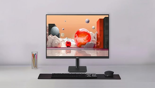 An LG monitor on a desk displaying 3D abstract art, accompanied by a keyboard, mouse, and pen holder.