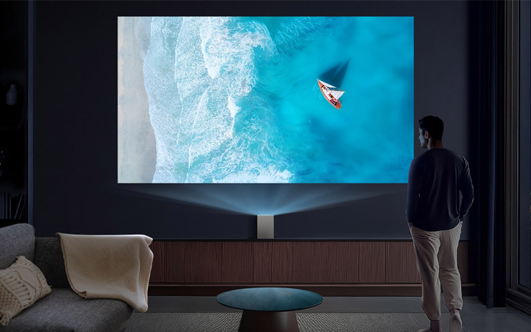 A man watching an LG OLED TV in the living room.