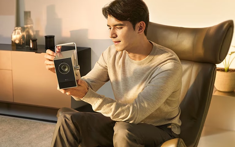  man looking at an LG 4K projector