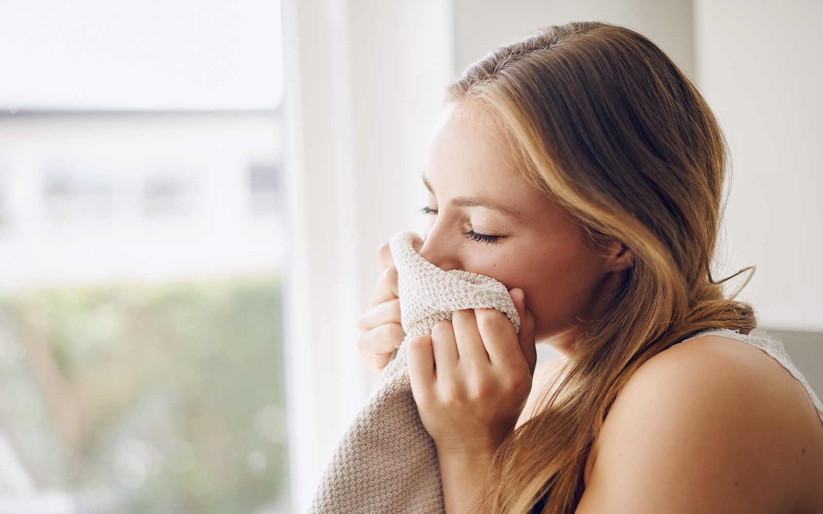A woman smelling laundry