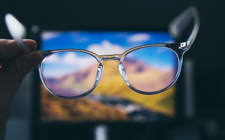 photo of a person holding glasses in their hand