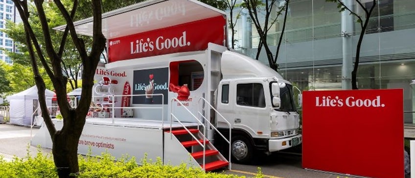 An event is taking place on a truck with the words 'Life is good' written on it.