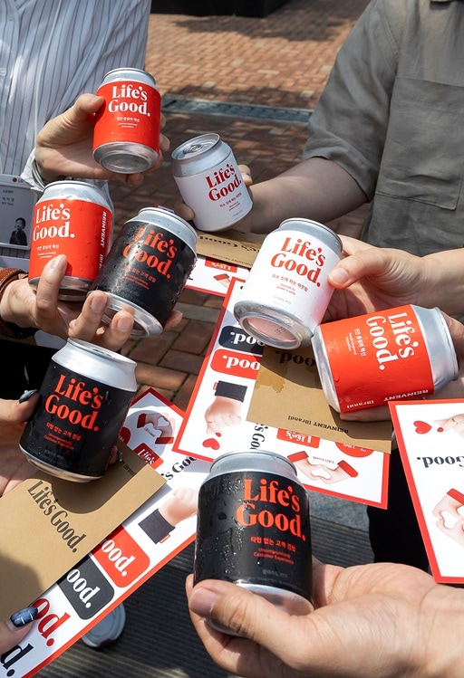 Stickers and canned beverages with the Life's good logo