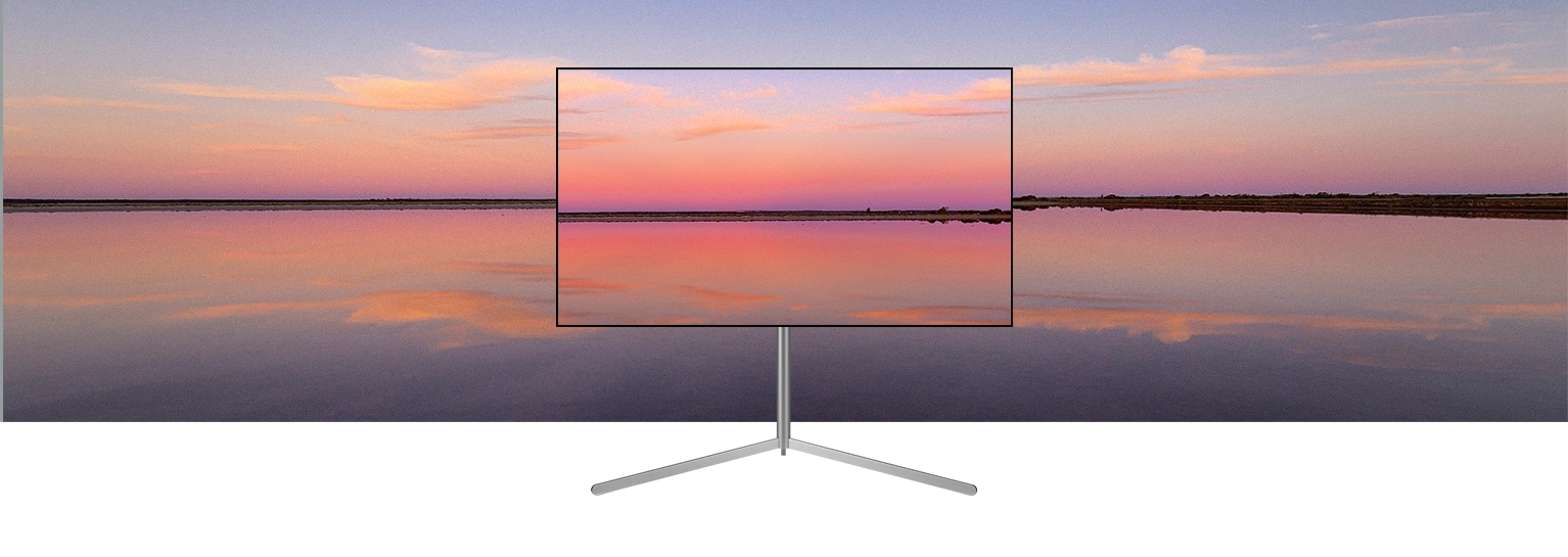 Egy galériaállványon lévő LG OLED televízión kék és rózsaszín naplemente látható, mely beleolvad a háttérbe