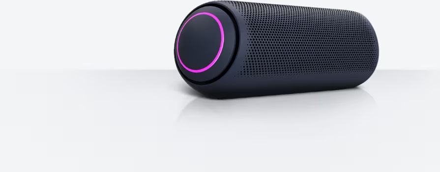 LG XBOOM Go PN7 with magenta lighting is placed on a grey surface.