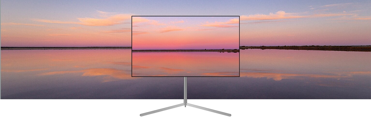 Telewizor OLED LG znajduje się w nowoczesnym szarym wnętrzu naprzeciwko okna wychodzącego na basen. Telewizor OLED LG znajduje się w neutralnie urządzonym wnętrzu z widocznymi cegłami, drewnianymi detalami i zielenią.