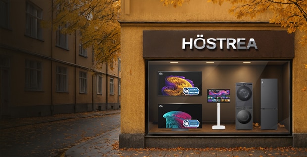 Skyltfönster med texten "HÖSTREA" visar LG-produkter inklusive en TV, laptop, WashTower tvättmaskin/torktumlare och ett kylskåp. Höstlöv och varma färger signalerar en höstkampanj