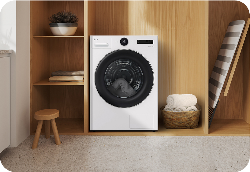 LG front load washing machine placed in a modern wooden cabinet space highlighting compact design and efficient laundry use