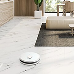 There is an LG CordZero™ placed on the floor of the living room, among the arranged furniture.