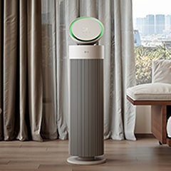 The LG PuriCare AeroBooster is installed in a bright living room.
