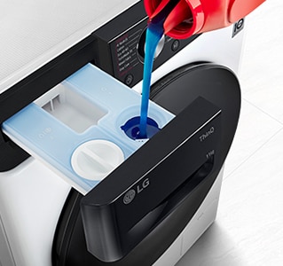 Detergent is pouring into the washing machine's detergent container.