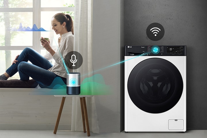 A woman controls an LG smart washing machine with voice commands from her smartphone near a window.