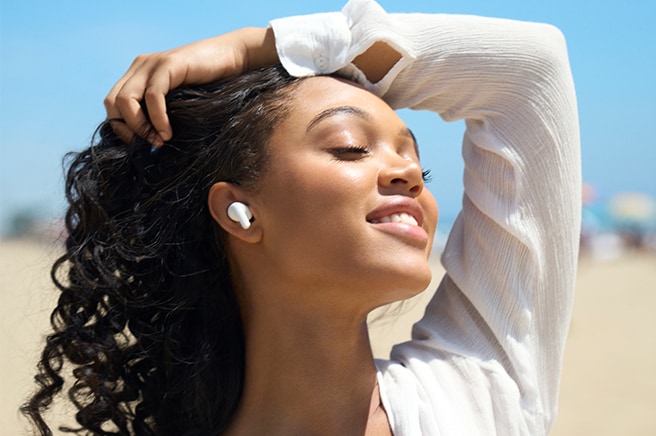 A person is lying in bed sleeping peacefully while wearing T90 earbuds.