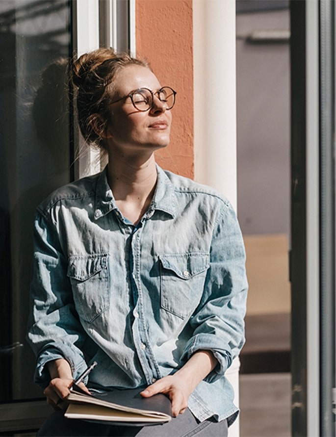 A woman soaking in the sun rays whilst taking a break from work